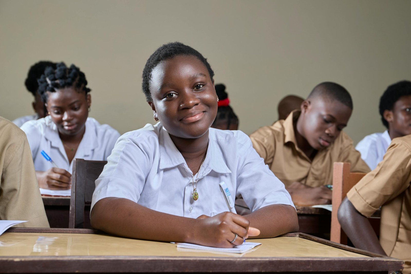 Engaged students studying in a diverse classroom environment, showcasing educational commitment.
